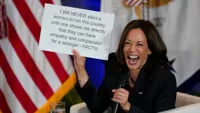 Kamala Harris holding sign