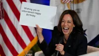 Kamala Harris holding sign