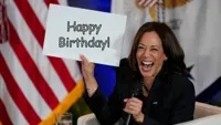 Kamala Harris holding sign