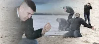 Guy with sand in the hands of despair