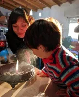 child spitting on a birthday cake