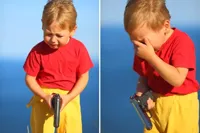 crying kid with gun