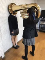 Girl Putting Tuba on Girl's Head