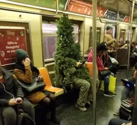 Man in Christmas Tree Costume on Subway