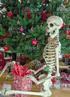 Skelton Waiting By Christmas Tree