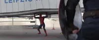 spider man holding a large object